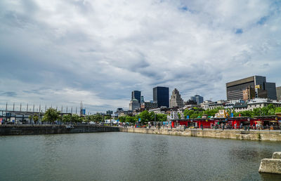 City by river against sky