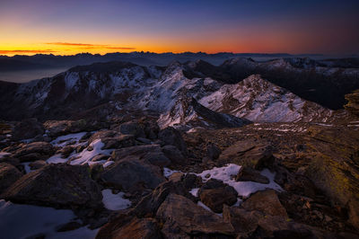 Scenic view of snowcapped mountains against sky during sunset