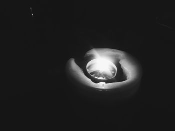 Close-up of lit candle in dark room