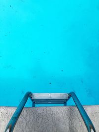 High angle view of swimming pool with a metal ladder