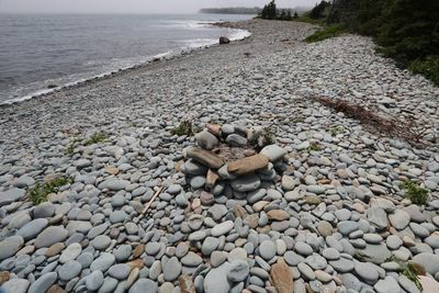 Pebbles on beach against sky