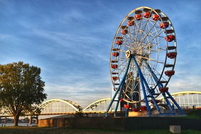 Low angle view of ferris wheel against sky