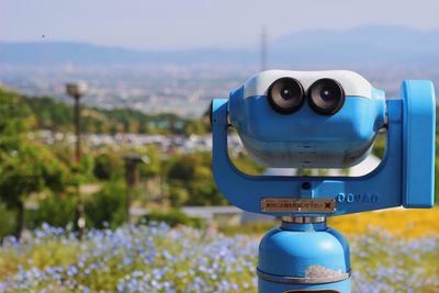 Close-up of coin operated binoculars facing landscape