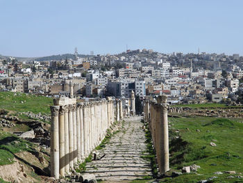 View of buildings in city against clear sky