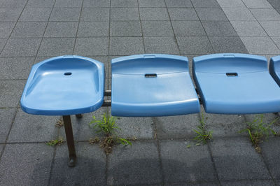 High angle view of empty chairs on sidewalk