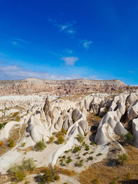 Scenic view of rocky landscape against blue sky