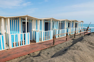 Built structure on beach against blue sky