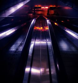 Illuminated railroad tracks at night