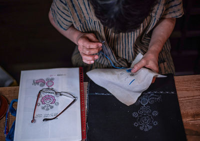 High angle view of woman making face on table