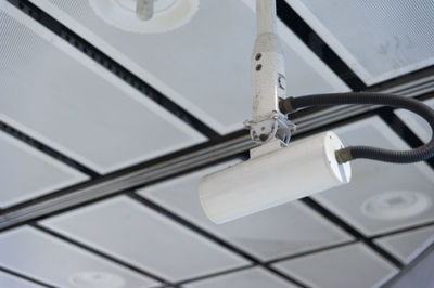 Low angle view of security camera on ceiling