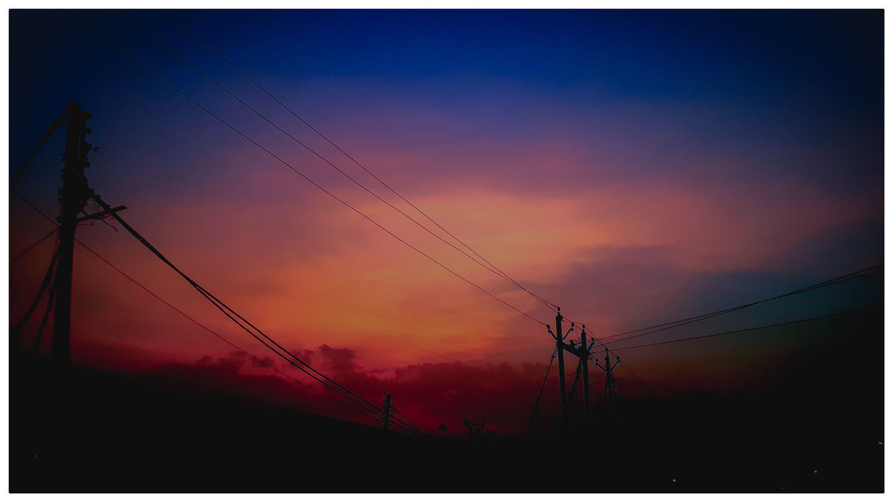 LOW ANGLE VIEW OF SILHOUETTE ELECTRICITY PYLONS AGAINST SKY AT SUNSET