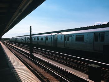 Train at railroad station against sky