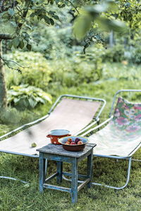 Empty chairs and table in lawn