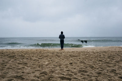 Rear view of man standing on beach