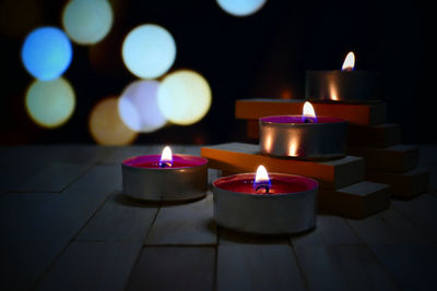 Close-up of illuminated tea light candles in temple