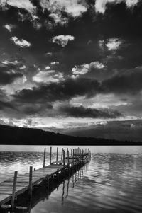 Pier on lake against sky