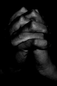 Close-up of human hand against black background