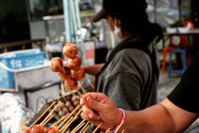 Cropped hand of man holding sweet food