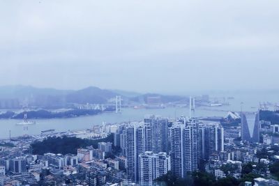 High angle view of buildings in city against sky