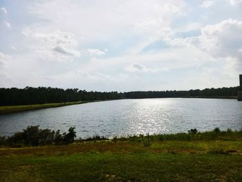 Scenic view of lake against cloudy sky