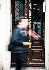 Blurred motion of man walking in city