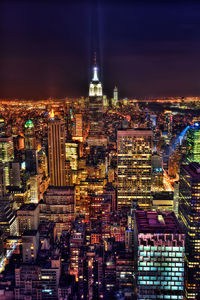 Aerial view of illuminated buildings in city at night