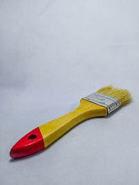High angle view of bird on table against white background