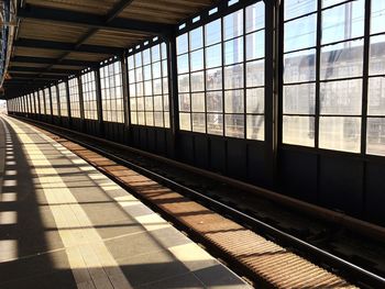 Railroad station platform seen through train window