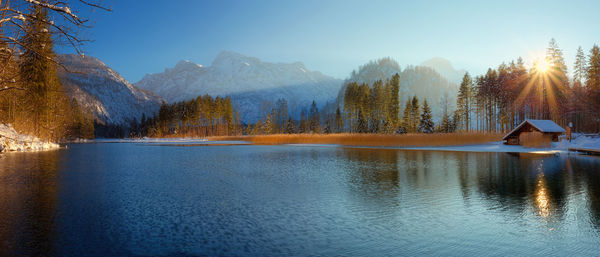 Scenic view of lake by trees against sky