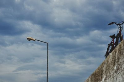 Low angle view of man on bicycle against sky