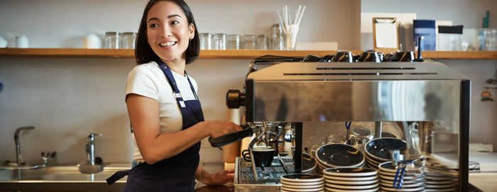 Portrait of young woman working in cafe