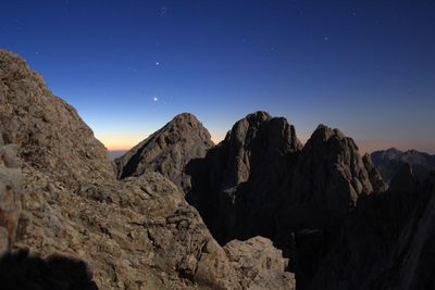 Scenic view of rocky mountains against clear blue sky