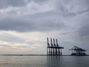 Silhouette pier on sea against sky during sunset