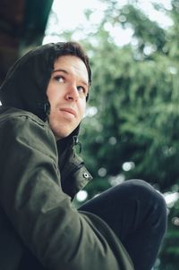 Portrait of young man sitting outdoors