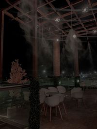 Empty chairs and tables in restaurant at night