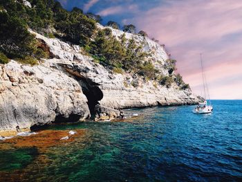 Scenic view of rock formation in sea against sky