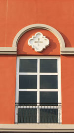 Low angle view of clock on wall of building