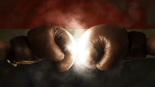 Cropped image of boxers fighting against illuminated croatian flag