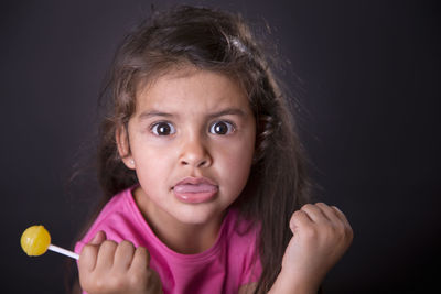 Portrait of girl against black background