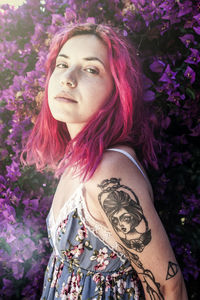 Portrait of beautiful woman with red flower