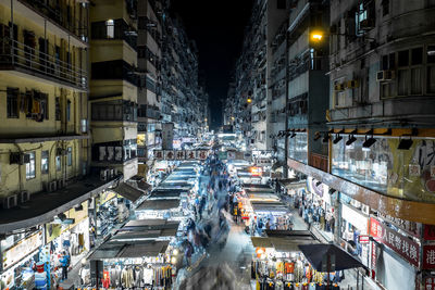 Market in illuminated city at night