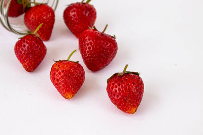 High angle view of strawberries on table against white background
