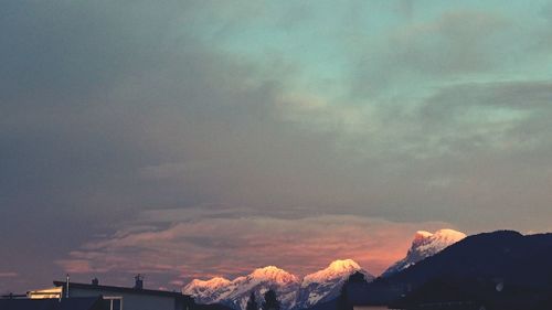 Storm clouds over mountains during sunset