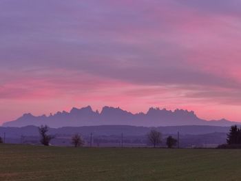 Scenic view of field against sky during sunset