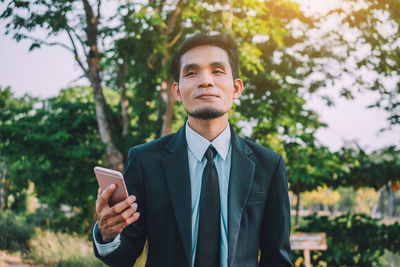 Portrait of young man standing outdoors