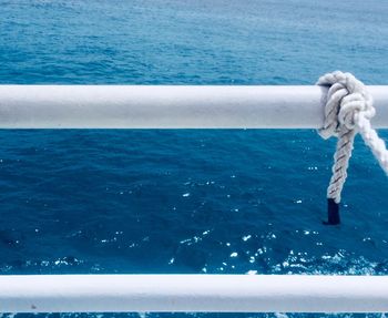 Close-up of rope tied on boat sailing in sea