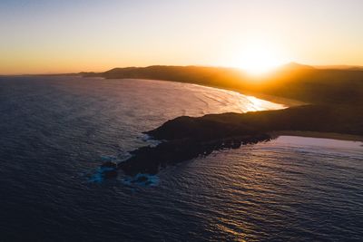 Scenic view of sea against clear sky during sunset