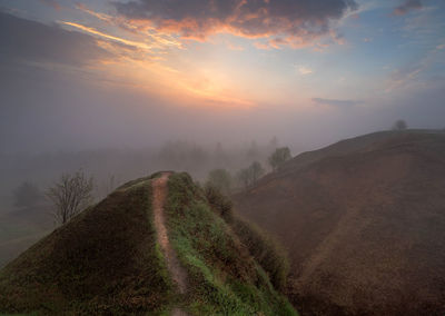 Scenic view of field against sky during sunset