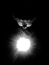 Close-up of illuminated lamp against black background