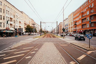 City street and buildings against sky